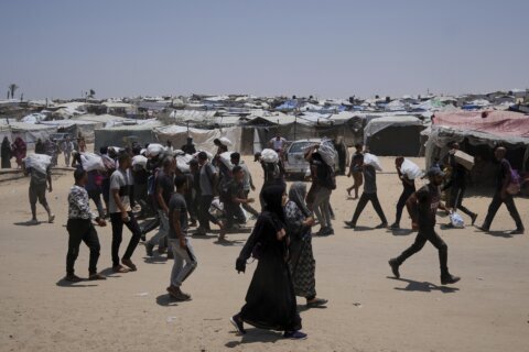 Palestinians say Israeli fire kills 12 near aid sites. Israel says it fired warning shots